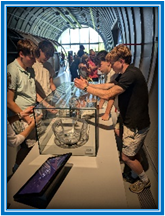 students in the Cern facility looking at machinery